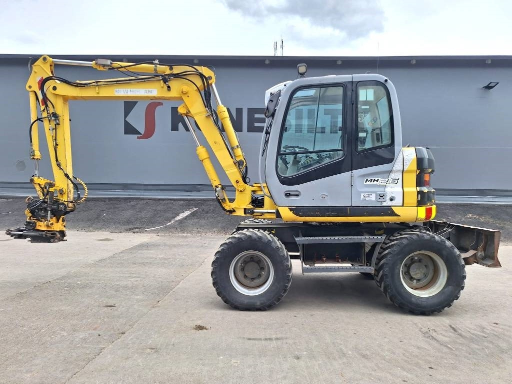 New Holland MH2.6 ENGCON PIHDEILLÄ - Колёсный экскаватор: фото 1 New Holland MH2.6 ENGCON PIHDEILLÄ - Колёсный экскаватор: фото 1