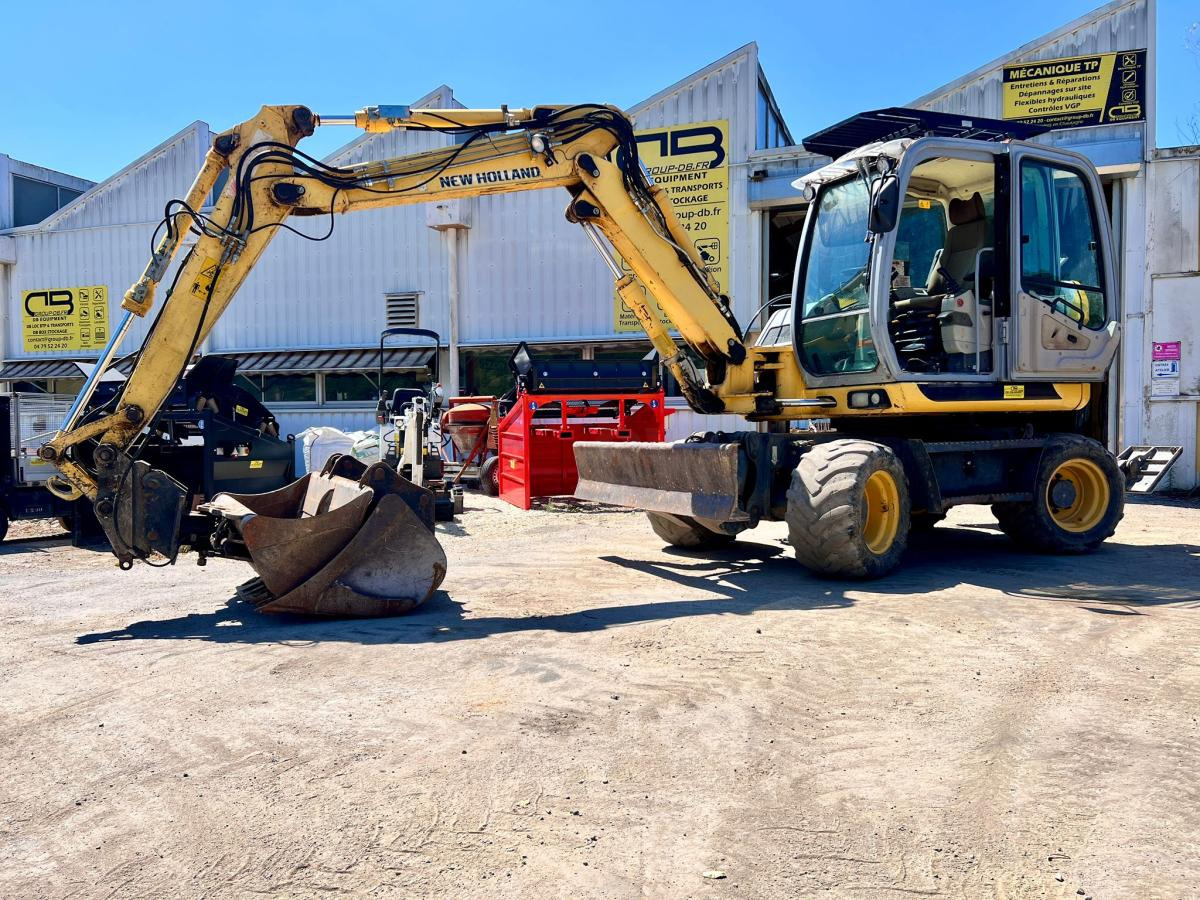 New Holland MH 2.6 PELLE A PNEUS 10T - Колёсный экскаватор: фото 1 New Holland MH 2.6 PELLE A PNEUS 10T - Колёсный экскаватор: фото 1