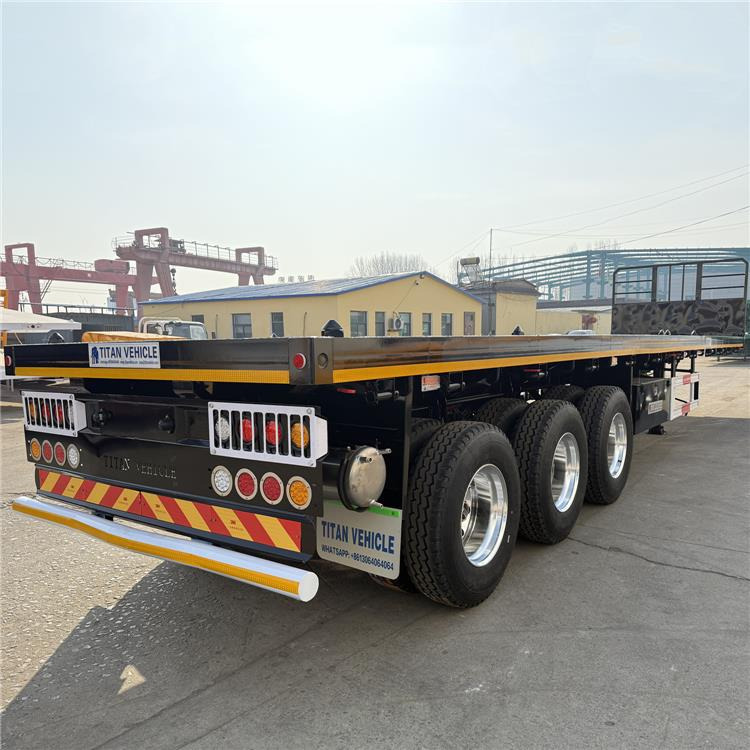 TITAN 12.5M 3 Axle Flat Deck Trailer for Sale In Tanzania - Полуприцеп-контейнеровоз/ Сменный кузов: фото 1 TITAN 12.5M 3 Axle Flat Deck Trailer for Sale In Tanzania - Полуприцеп-контейнеровоз/ Сменный кузов: фото 1
